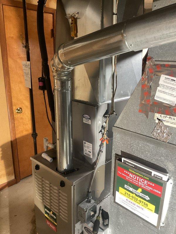 Responded to service call for one-year-old air conditioning system not operating properly. Upon arrival, verified thermostat settings on Sensi WiFi-enabled unit displaying 69°F room temperature with system in cooling mode. Inspected residential HVAC installation in mechanical room, including furnace unit with ductwork and electrical panel connections. Performed diagnostic evaluation of AC system, checked thermostat programming and wireless connectivity, verified proper power supply to equipment, and inspected electrical connections at breaker panel. Documented system configuration with photos showing thermostat interface and mechanical room equipment layout. System restored to proper cooling operation and customer contacted prior to arrival as requested.