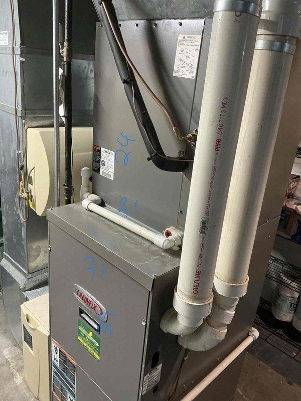 Completed comprehensive estimate for full HVAC system replacement of 19-year-old equipment. Evaluated existing Lennox furnace installation in basement with Schedule 40 PVC venting system and associated ductwork, along with outdoor condenser unit positioned on weathered concrete pad against brick exterior. Documented current system configuration including refrigerant lines, electrical connections, condensate drainage, and overall equipment condition to provide replacement recommendations and specifications.