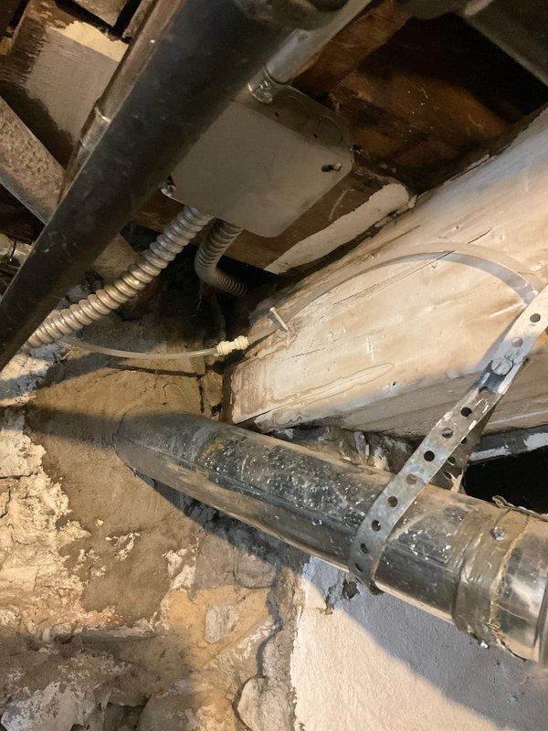 Responded to emergency call for leaking water heater in 110-year-old residential property. Upon arrival, inspected four-year-old Bradford White tanked water heater installed in basement utility area and confirmed active water leak from unit. Documented existing installation configuration including copper supply lines with brass fittings, white PVC venting system, and current electrical connections via metallic flex conduit to junction box. Assessed leak severity and determined replacement necessary due to tank failure. Photographed existing installation setup, mechanical room conditions, and surrounding plumbing infrastructure for documentation purposes prior to recommending next steps for water heater replacement.