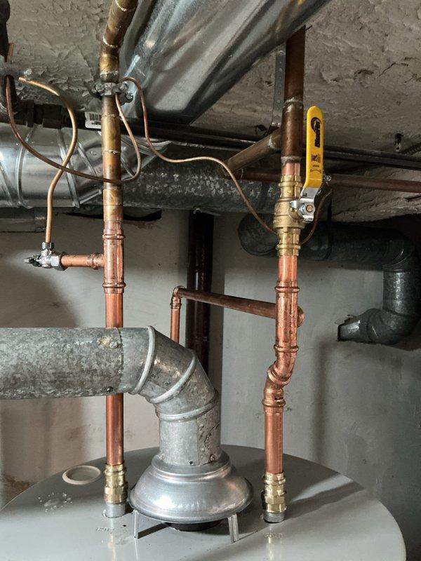 Responded to service call for leaking 40-gallon Bradford White residential water heater located in basement utility space. Upon inspection, identified active leak requiring unit replacement. Disconnected existing water heater from copper supply lines, gas line, and exhaust flue system. Removed failed unit and installed new 40-gallon water heater with proper venting configuration. Connected hot and cold water copper piping with appropriate brass fittings, installed pressure relief valve with discharge pipe, and reconnected gas supply line to burner assembly. Tested all connections for leaks, verified proper gas combustion, and confirmed temperature and pressure relief valve operation. System restored to full working condition.