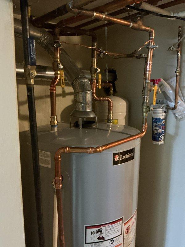 Replaced 75-gallon Lochinvar water heater under warranty with complete reconnection of copper supply and distribution piping, including installation of expansion tank, circulation pump, and associated valves and fittings. Repaired burst pipe in pool room area with new copper piping sections and proper soldered connections to restore water flow and prevent further water damage.