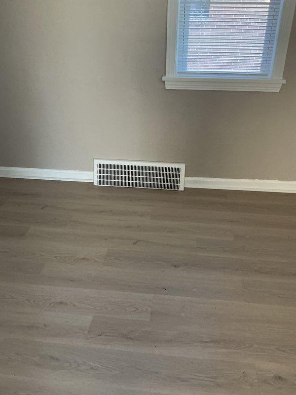 Conducted on-site evaluation for add-on air conditioning installation at rental property. Assessed existing furnace and ductwork infrastructure in basement mechanical room to determine compatibility and requirements for new AC system integration. Documented current HVAC setup including gray furnace unit with existing duct distribution system running through exposed ceiling space. Evaluated floor register locations and airflow pathways in upper living areas to ensure proper cooling distribution. Provided estimate for complete air conditioning system addition including outdoor condensing unit, evaporator coil installation, refrigerant line set, electrical connections, and integration with existing forced-air heating system.