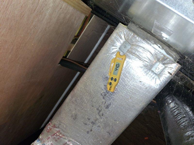 Responded to no cooling complaint on 3-year-old air conditioning system. Upon arrival, performed diagnostic testing of the cooling system using calibrated digital measurement tools. Conducted thorough inspection of ductwork in attic space, measuring temperature differentials at multiple points along the supply ducts to identify system performance issues. Found flexible and rigid ductwork sections with proper insulation intact. Recorded temperature readings of 351°F at supply duct locations to verify system operation. Tested airflow distribution through duct system and confirmed proper sealing at connection points. Completed diagnostic assessment of entire cooling system including attic-mounted ductwork components. Documented findings with photographic evidence showing measurement readings and duct conditions. System operational upon completion of service call.