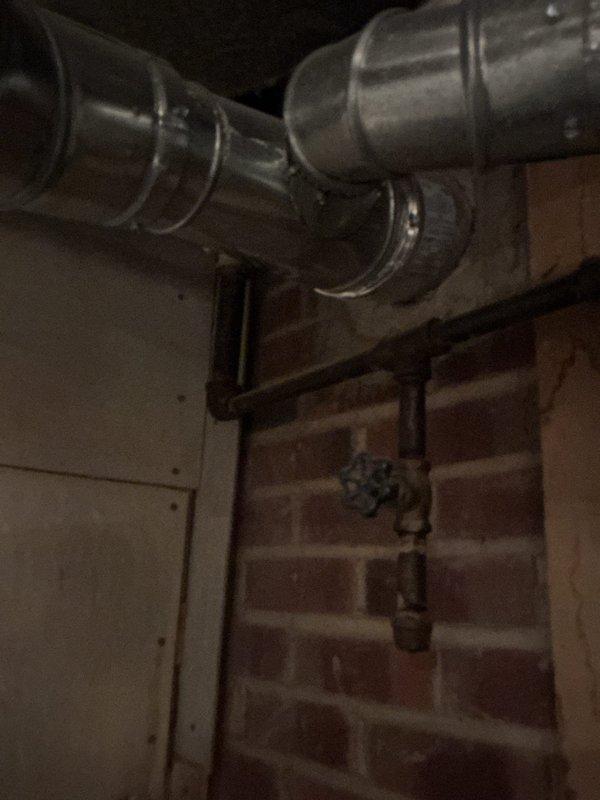 Performed comprehensive cooling system maintenance on a twenty-year-old air conditioning unit that was operating properly at time of service. Conducted standard AC tune-up procedures including system inspection, performance verification, and documentation of existing equipment condition. Photographed basement-mounted furnace installation and associated mechanical components for service records.
