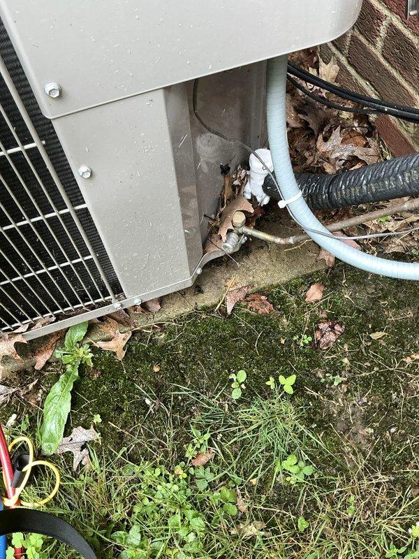 Responded to service call for 1.5-year-old Bryant AC system under warranty with insufficient cooling and inability to reach setpoint temperature. Upon inspection, found unit in frozen condition requiring thaw-out period before proper diagnostics could be performed. Connected testing equipment to outdoor condensing unit and documented current system state with photos showing unit placement, electrical connections, and condenser coil assembly. Second appointment scheduled to complete diagnostic testing and determine root cause of freezing issue once unit has fully thawed.