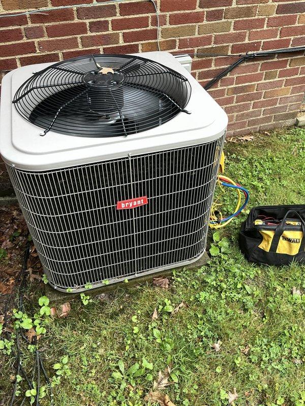 Responded to service call for 1.5-year-old Bryant AC system under warranty with insufficient cooling and inability to reach setpoint temperature. Upon inspection, found unit in frozen condition requiring thaw-out period before proper diagnostics could be performed. Connected testing equipment to outdoor condensing unit and documented current system state with photos showing unit placement, electrical connections, and condenser coil assembly. Second appointment scheduled to complete diagnostic testing and determine root cause of freezing issue once unit has fully thawed.