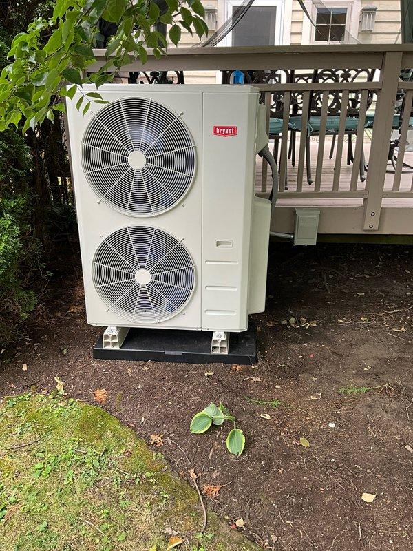 Successfully installed a new Bryant 4-zone ductless mini split heat pump system with three wall-mounted indoor units in the kitchen, master bedroom, and guest bedroom, plus one console-style unit in the third-floor bedroom. The outdoor condenser was positioned behind the deck on a mounting pad as specified. Ran new copper refrigerant lines, communicating wires, and condensate drains from the outdoor unit to all four indoor units, enclosing all linesets with plastic linehide material for a finished appearance. Installed new dedicated electrical circuit from the main electrical panel to the outdoor condenser to provide proper power supply for system operation. All indoor units mounted securely with remote controls and documentation provided for operation.