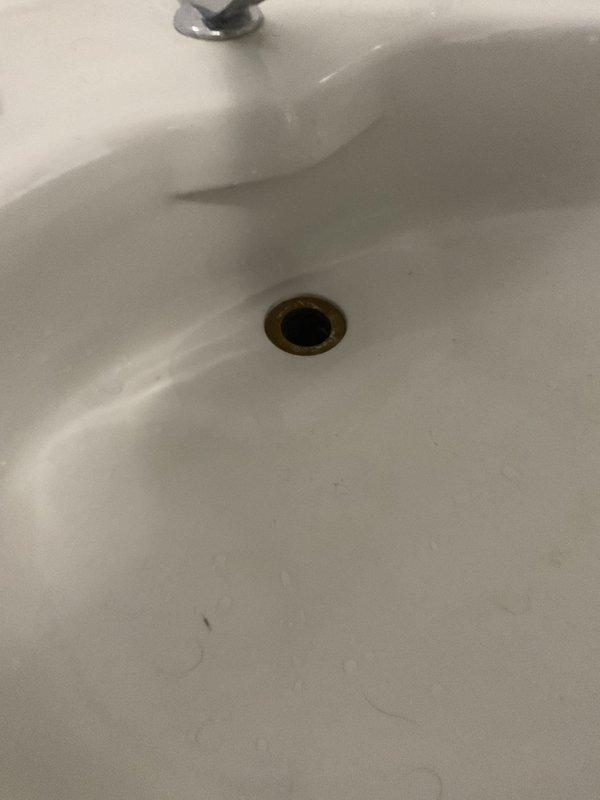 Responded to a residential plumbing emergency at a century-old home experiencing multiple water system failures. Upon arrival, assessed a severely corroded gate valve assembly with visible rust deterioration and active leaking at connection points, causing water damage and pooling on the concrete floor beneath the installation. Addressed a malfunctioning outdoor faucet that had ceased operation due to age-related component failure. Completed necessary repairs to the compromised valve system, replacing deteriorated sections of piping where corrosion had compromised structural integrity. Restored proper water flow and pressure throughout the affected areas, ensuring all fixtures returned to normal operation. Documented the existing plumbing infrastructure conditions, noting the mixed-material pipe configuration of aged metal and PVC components typical of retrofitted systems in historic properties.