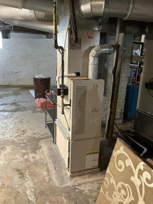 Completed comprehensive evaluation of two HVAC systems, both exceeding 20 years of service life, located in basement mechanical room. Assessed beige vertical furnace unit with connected ductwork system and accompanying equipment including water treatment system and electrical components. Based on age and condition of equipment, provided detailed replacement estimate for both heating and cooling systems to ensure reliable climate control and improved energy efficiency.