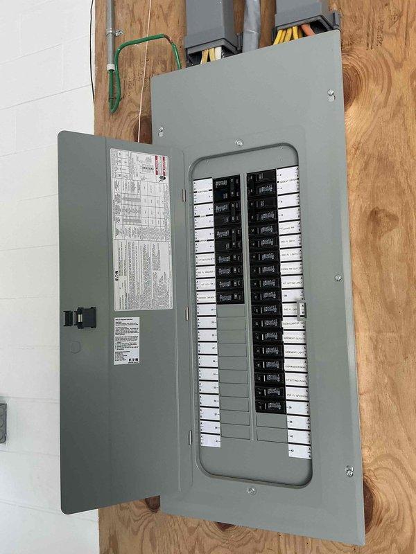Completed estimate for mini split installation to heat and cool room above garage. Assessed electrical panel location in unfinished space with exposed framing and confirmed adequate breaker capacity for new mini split system. Evaluated bedroom layout and measured wall space to determine optimal placement of indoor air handler unit for efficient air distribution throughout the space.