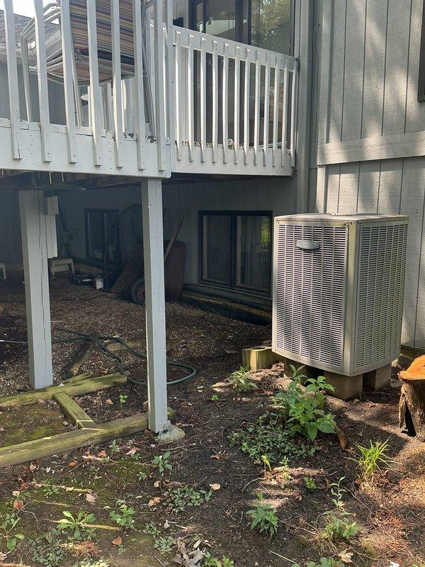 Responded to estimate request for residential HVAC system experiencing refrigerant leak. Evaluated existing outdoor heat pump unit located beneath elevated deck structure and documented current system condition with photographic evidence. Provided comprehensive replacement quote reference number 2377 for new equipment installation.
