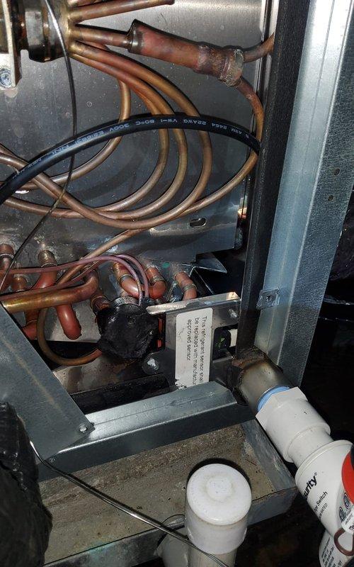 Returned to site to complete rewiring of HVAC system as previously scheduled. Accessed equipment compartment and verified all refrigerant line connections and electrical components. Completed proper wiring connections at thermostat base plate, ensuring all terminals (R, C, Y, W, G) were securely fastened per manufacturer specifications. Documented equipment condition with photos showing copper refrigerant lines, electrical relay components, and completed thermostat wiring configuration. System wiring now complete and ready for operational testing.
