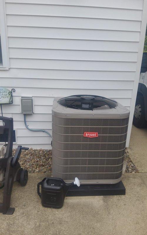 Responded to no-cooling call on one-year-old Bryant air conditioning system. Upon arrival, found unit completely non-operational with no power to outdoor condenser. Traced issue to tripped breaker at electrical panel in basement. Inspected disconnect box and electrical connections at outdoor unit—all wiring secure with no signs of damage or overheating. Reset breaker and restored power to system. Unit started successfully with compressor and condenser fan operating normally. Verified proper amperage draw and confirmed system cooling effectively. No underlying electrical faults detected; likely nuisance trip due to momentary power fluctuation.
