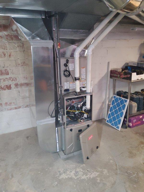 Completed installation of two Bryant 97% high-efficiency gas furnaces for duplex property, each featuring single-stage heating with multi-speed ECM blower motors. Installed new programmable thermostats and condensate pumps for both units to handle high-efficiency condensation removal. Fabricated and installed return air ductwork to enclose previously open returns, bringing system into compliance with current municipal building codes. All ductwork connections secured with proper supports and fasteners, electrical conduit run to code specifications, and units tested for proper operation and safety.