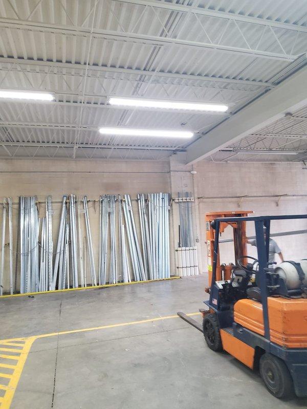 Intercepted existing cold water supply line at utility sink location and installed approximately 75 feet of water line routed overhead through the interior of the industrial building to supply a new hose bib. All piping work was completed inside the facility, with lines run along the ceiling structure and down the wall to the new fixture location.
