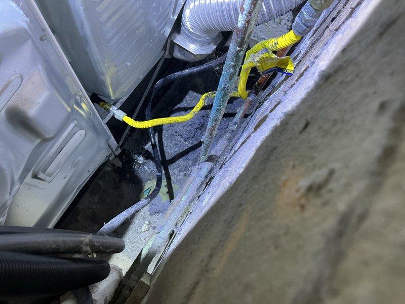 Responded to gas leak at dryer connection line over two consecutive service visits. Initial repair attempt on first visit did not resolve the issue. Returned for follow-up service where gas utility company confirmed active leak persisting at dryer gas line connection point. Documented conditions with photographs showing utility area infrastructure and plumbing systems. Coordinated access procedures and obtained necessary approvals prior to proceeding with repairs.