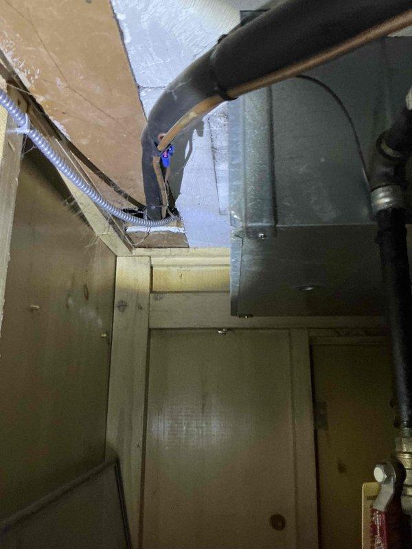 Responded to service call for non-operational air conditioning system. Upon inspection of the basement mechanical space, evaluated the existing HVAC equipment including the furnace unit, associated ductwork, and refrigerant lines. Documented the current system configuration with photographs showing the furnace installation, water heater proximity, copper refrigerant piping with insulation, metallic flexible ductwork, and overall mechanical room layout. Assessed equipment condition and prepared comprehensive replacement estimate for new air conditioning system to restore cooling functionality to the residence.