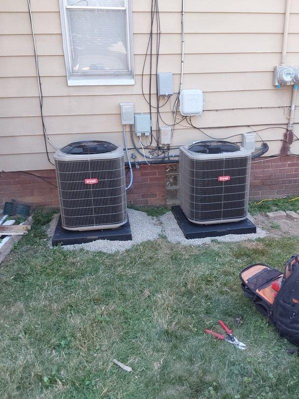 Completed full HVAC system replacement including installation of two Bryant furnaces with matching evaporator coils and two Bryant condensing units positioned on composite pads against the building foundation. Installed new refrigerant linesets with proper insulation, ran electrical disconnects and control wiring to outdoor units with appropriate conduit and junction boxes mounted to exterior siding, and connected all ductwork including supply and return air plenums. Modified and tied back first floor return ductwork to integrate with new equipment configuration, ensuring proper airflow distribution throughout the system. All installations performed to manufacturer specifications with secure mounting, proper clearances, and code-compliant electrical connections.
