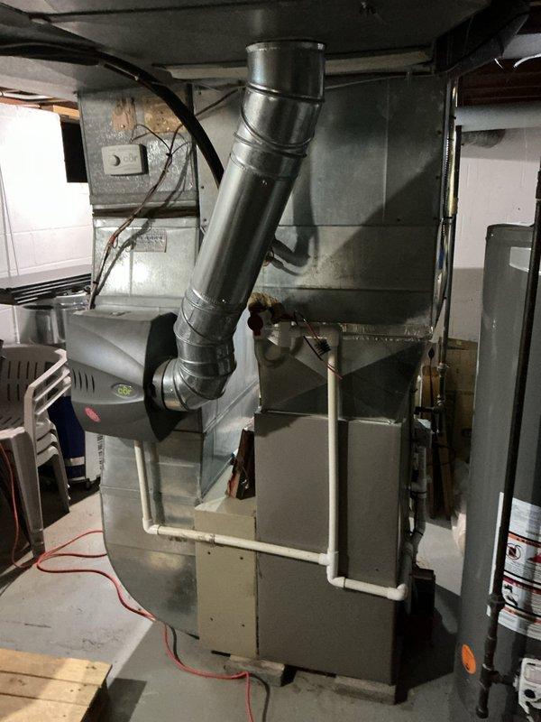 Responded to no cooling complaint on 13-year-old system found completely empty of refrigerant. Evaluated existing Bryant furnace and air conditioning equipment for repair versus replacement options, documented current installation including ductwork and venting configuration. Provided estimate for complete system replacement due to age of equipment and refrigerant loss, awaiting customer decision to proceed.
