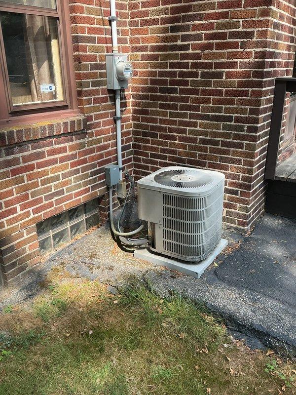 Completed follow-up estimate for furnace replacement with possible air conditioning system addition. Evaluated existing outdoor condensing unit positioned on concrete pad against brick exterior wall, noting current refrigerant line routing and electrical service connections including meter socket, conduit system, and disconnect box. Documented existing installation configuration and assessed placement options for new equipment. Created site diagram worksheet mapping property lines, neighboring addresses, front and rear yard areas, and multiple potential condensing unit placement locations to optimize installation while maintaining proper clearances and code compliance. Photographed current HVAC setup showing unit positioning, electrical infrastructure, and refrigerant line paths for accurate equipment sizing and installation planning. Customer expressed interest in straightforward replacement approach without premium features, pending competitive pricing for combined furnace and air co