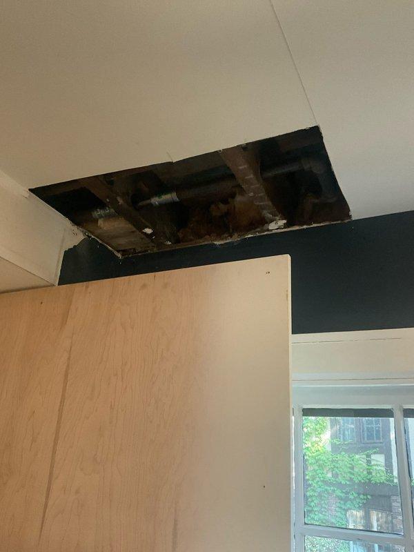 Completed drain line repair for sink by exposing and accessing concealed plumbing within ceiling cavity. Opened ceiling to locate and assess deteriorated drain pipe, removed damaged section, and installed new drain line with proper fittings and secure connections. Restored proper drainage function and ensured all connections were leak-free and code-compliant.