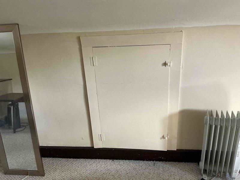 Conducted on-site assessment for mini split installation in attic space. Evaluated existing heating system consisting of portable oil-filled radiators and documented current room conditions including electrical outlet locations, wall construction, and available mounting surfaces. Photographed installation area to determine optimal placement for indoor air handler unit and provided estimate for ductless mini split system.