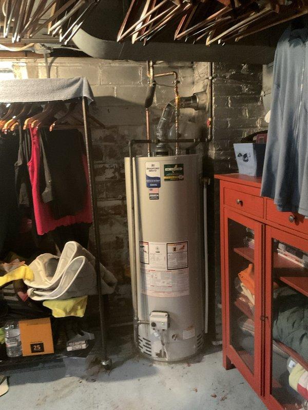 Performed drain snaking service to clear obstruction in kitchen sink drain line. Successfully cleared blockage and restored proper drainage flow. Installed new 50-gallon, 40,000 BTU short water heater in basement utility area. Connected copper supply lines to unit, verified proper venting configuration, and tested all connections for leaks. Confirmed water heater operation and adequate hot water delivery throughout system. Inspected under-sink plumbing assembly, verified P-trap configuration and all PVC connections are secure and functioning properly. All work completed to code specifications with system operating as intended.