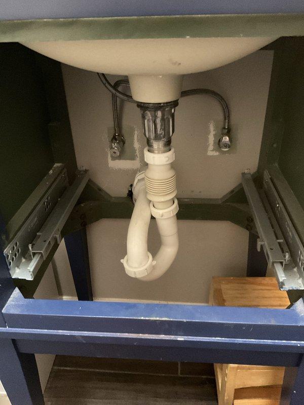 Performed drain snaking service to clear obstruction in kitchen sink drain line. Successfully cleared blockage and restored proper drainage flow. Installed new 50-gallon, 40,000 BTU short water heater in basement utility area. Connected copper supply lines to unit, verified proper venting configuration, and tested all connections for leaks. Confirmed water heater operation and adequate hot water delivery throughout system. Inspected under-sink plumbing assembly, verified P-trap configuration and all PVC connections are secure and functioning properly. All work completed to code specifications with system operating as intended.