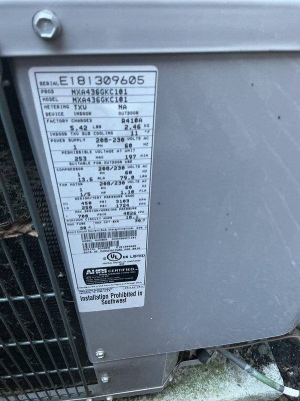 Completed scheduled cooling tune-up on a 4-year-old residential cooling system consisting of an outdoor condenser unit (Model NXA436GKC101, Serial E181309405) and indoor air handler. Performed comprehensive maintenance inspection including visual assessment of outdoor unit positioned in landscaped area against brick wall, verified unit accessibility, checked refrigerant charge specifications (factory charge 9.42 lbs), confirmed electrical ratings (208-230V), and documented equipment condition through photographic records showing proper installation and adequate clearances around condenser with protective grille intact.