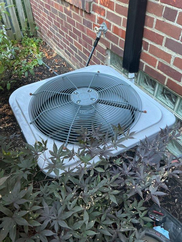 Completed scheduled cooling tune-up on a 4-year-old residential cooling system consisting of an outdoor condenser unit (Model NXA436GKC101, Serial E181309405) and indoor air handler. Performed comprehensive maintenance inspection including visual assessment of outdoor unit positioned in landscaped area against brick wall, verified unit accessibility, checked refrigerant charge specifications (factory charge 9.42 lbs), confirmed electrical ratings (208-230V), and documented equipment condition through photographic records showing proper installation and adequate clearances around condenser with protective grille intact.