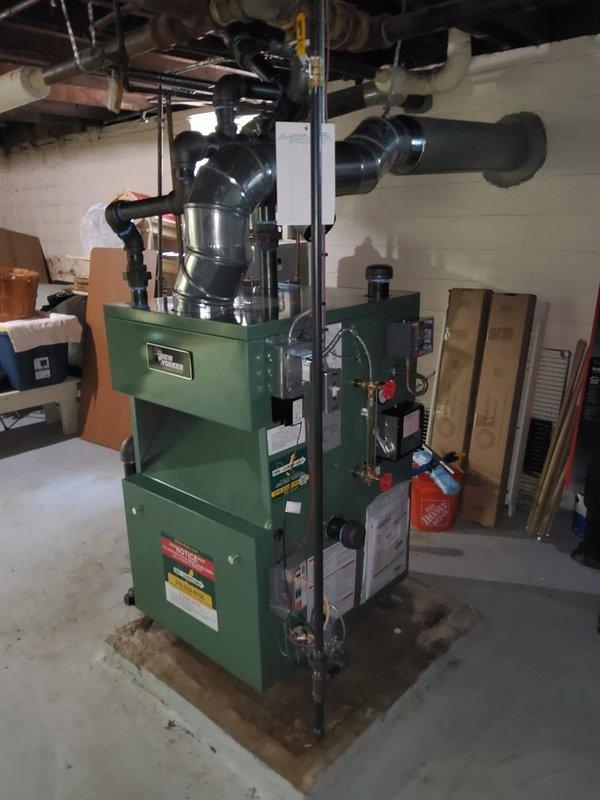 Completed installation of New Yorker steam boiler model CGS60C with all associated components including automatic water feeder, low water cutoff, sight glass, pressure control, and programmable thermostat. Installed new backflow preventer and modified all near boiler piping to meet current specifications. Ran dedicated electrical circuit to panel and terminated connections for boiler operation. Corrected pitch on radiator supply piping to resolve heating issue in bedroom, ensuring proper steam flow and condensate return.