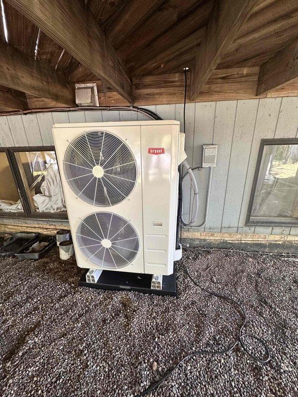 # HVAC Complete System Installation

Successfully completed a full HVAC system replacement in a residential basement utility room. Installed a new Bryant furnace with matching evaporator coil, heat pump system, and Ecobee smart thermostat. The indoor furnace unit was positioned in the basement mechanical room alongside existing water heater, with proper clearances maintained for service access and safety compliance.

Relocated the outdoor heat pump condenser unit to a protected location beneath the deck structure, strategically positioned between two windows for optimal airflow and aesthetic considerations. The unit was mounted on a level pad with gravel base for drainage and stability. Electrical conduit was professionally routed along the exterior wall, and refrigerant lines were properly insulated and connected between indoor and outdoor components.

All ductwork connections were completed with proper sealing, and condensate drainage system was installed with auxiliary pump as neede
