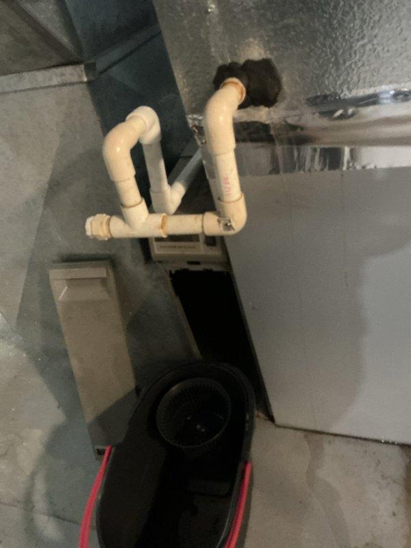 Responded to reported AC coil leak. Upon inspection, accessed the evaporator coil through the air handler opening and confirmed refrigerant leak at the indoor coil assembly. Documented existing conditions including coil access point, condensate drain system with pump assembly, and surrounding mechanical components for repair recommendations and customer review.