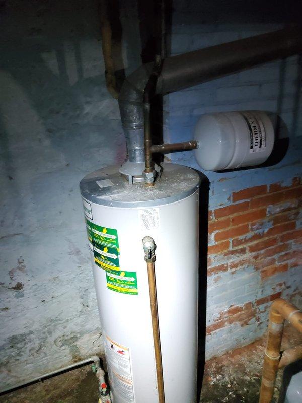 Responded to service call for non-operational tanked water heater with suspected pilot light issue. Upon arrival, inspected gas-fired water heater unit located in basement utility area. Assessed pilot assembly, thermocouple, and gas control valve for proper function. Verified gas supply to unit and checked for any safety lockouts. Relit pilot light following manufacturer specifications and confirmed stable flame. Tested burner ignition cycle and verified water heater returned to normal heating operation. Unit restored to full functionality.