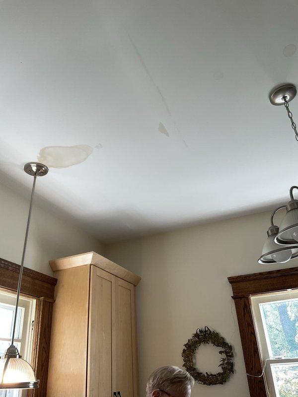 Responded to ceiling leak investigation in 114-year-old residential property. Upon arrival, conducted visual inspection of affected area revealing significant water staining with yellowish-brown discoloration patterns across ceiling surface, indicating active or recent moisture intrusion from above. Assessed bathroom directly above damaged ceiling area, examining all plumbing fixtures, supply lines, and drain connections for potential leak sources. Documented existing conditions through photographic evidence showing extent of water damage and staining patterns. Provided homeowner with findings and recommended further investigation to identify exact source of water intrusion, which may require accessing ceiling cavity or upper-level plumbing systems for definitive diagnosis.