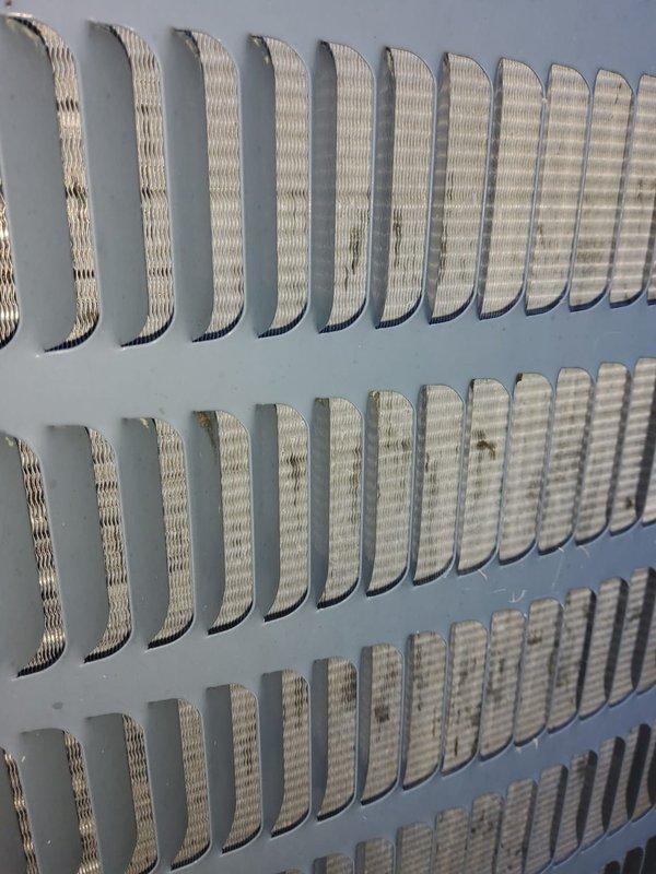 Responded to no cooling complaint on 10-year-old Goodman HVAC system where indoor fan was operating but unit was not producing cold air. Upon arrival, coordinated with multiple tenants on-site and performed diagnostic inspection of the furnace and air handler assembly located in utility room. Inspected outdoor condensing unit ventilation louvers and confirmed proper airflow through exterior grilles. Documented existing equipment conditions including water heater, furnace configuration, condensate pan positioning, and associated plumbing connections. System evaluation completed and photographic documentation captured for service records.