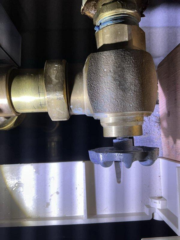 # Warranty Recall - Recurring Toilet Issue

Responded to third service call for recurring toilet malfunction. Upon inspection, discovered significant condensation and frost buildup on the brass flush valve assembly, indicating a temperature differential issue within the TOTO automatic flush system. The excessive moisture accumulation on the central valve body suggests a potential refrigerant line leak or faulty solenoid valve causing abnormal cooling of the brass components. 

Documented the plumbing installation within the wall cavity, noting the valve mechanism, brass fittings, threaded connections, and electronic control panel. The frost pattern on the valve assembly confirms this is the same underlying issue from previous service visits. Photographed the complete assembly including the mounting bracket, compression fittings, and electrical wiring for warranty documentation and further manufacturer review. Recommended escalation to manufacturer for potential recall or replacement of