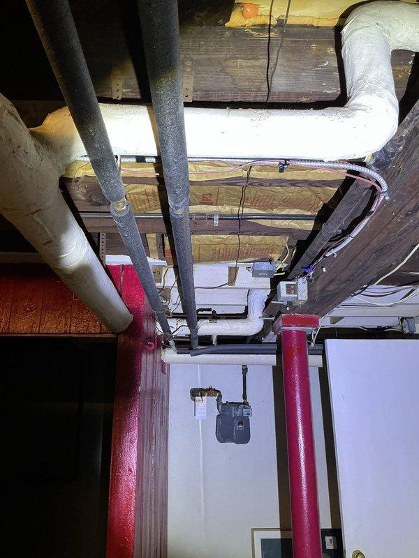 Performed on-site assessment of reported leaking pipe associated with existing tank-style water heater in basement utility area. Documented current plumbing configuration including copper supply lines, shut-off valves, and connections to determine source of leak and provided estimate for repair options including conventional water heater replacement or tankless system installation.