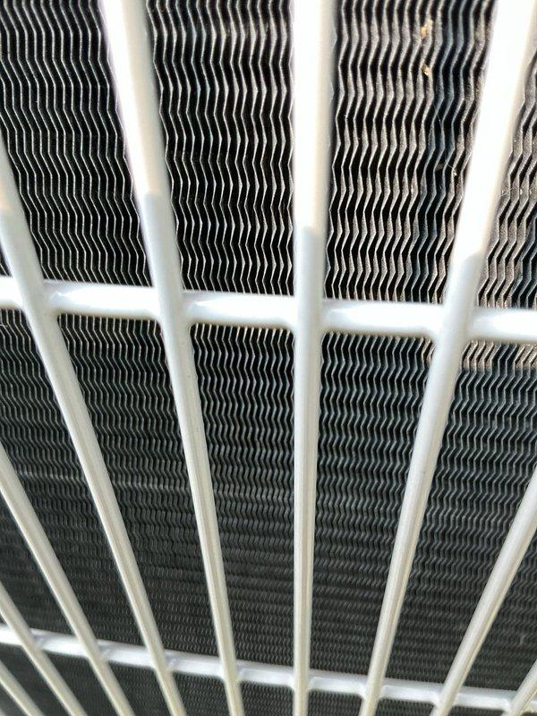 Responded to service call for air conditioning system repeatedly tripping circuit breaker. Upon inspection, discovered evaporator coil showing signs of restricted airflow due to accumulated debris and contamination visible on heat exchanger fins. Verified air filter was recently replaced with properly sized 16x30x1 plenum-rated filter. Checked electrical connections at air handler, inspected copper refrigerant lines for proper insulation and potential grounding issues, and examined condensate drain system for blockages that could cause electrical faults. Cleaned evaporator coil assembly, verified proper airflow through heat exchanger, and tested system operation under load to confirm circuit breaker stability and proper amp draw on the 2-year-old unit.