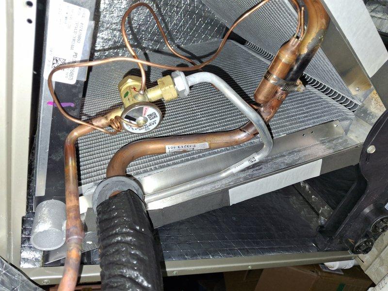 Performed refrigerant pump down procedure and removed defective thermostatic expansion valve (TXV) from HVAC system. Installed replacement TXV under parts warranty coverage, reconnected refrigerant lines, and recharged system to manufacturer specifications. Verified proper operation of expansion valve and confirmed system pressures and temperatures were within normal operating parameters upon completion.