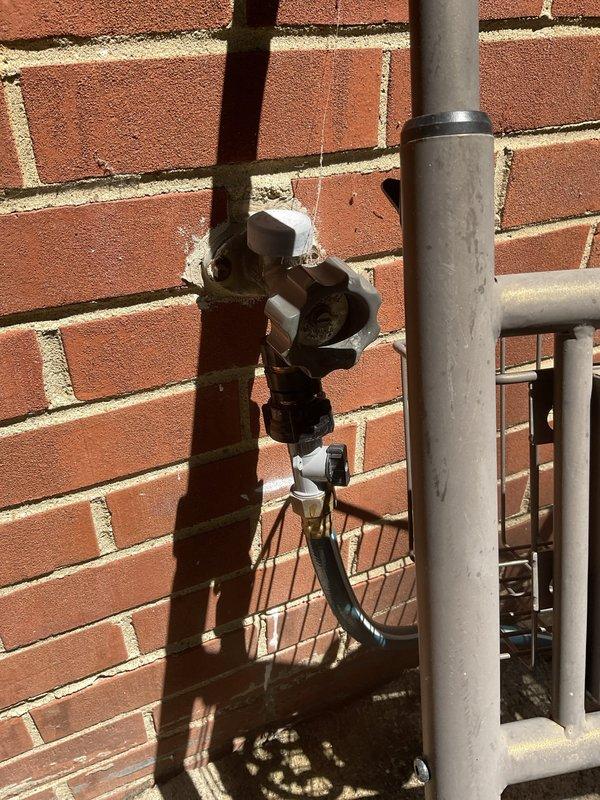 Responded to a water leak at a 60-year-old residential property where the main shutoff valve was actively leaking. Upon arrival, inspected the exterior utility installation mounted on the brick wall and identified the failing gate valve assembly as the source of the leak. Shut off the water supply at the meter, removed the deteriorated shutoff valve, and installed a new replacement valve with proper sealing and connections. Secured all piping with appropriate mounting brackets to ensure stability. Additionally, inspected the interior plumbing beneath the bathroom sink cabinet to verify no secondary leaks were present in the P-trap or supply line connections. Tested the new shutoff valve for proper operation and confirmed no leaks at any connection points. Restored full water service to the residence and verified adequate water pressure throughout the system.