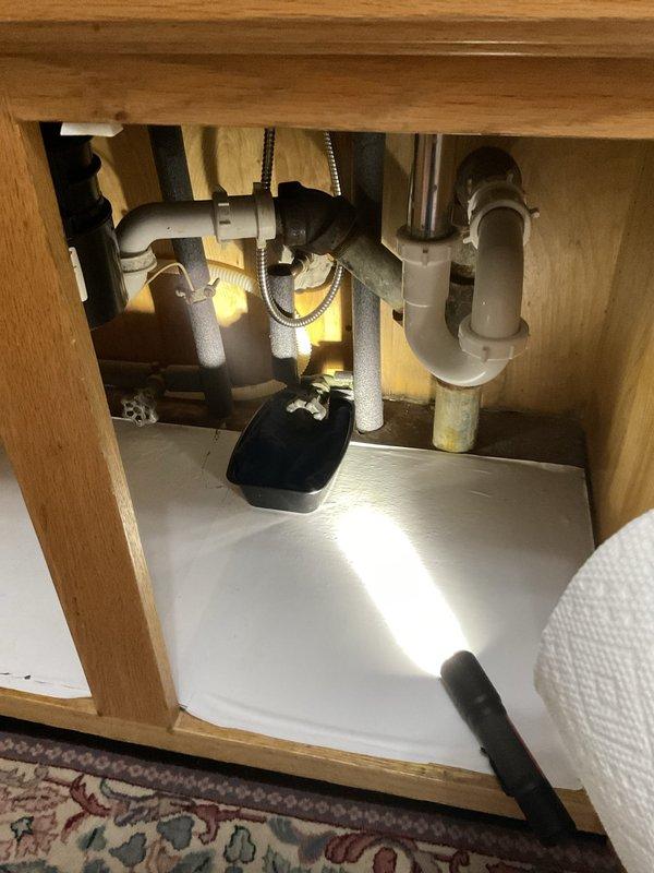 Responded to a water leak at a 60-year-old residential property where the main shutoff valve was actively leaking. Upon arrival, inspected the exterior utility installation mounted on the brick wall and identified the failing gate valve assembly as the source of the leak. Shut off the water supply at the meter, removed the deteriorated shutoff valve, and installed a new replacement valve with proper sealing and connections. Secured all piping with appropriate mounting brackets to ensure stability. Additionally, inspected the interior plumbing beneath the bathroom sink cabinet to verify no secondary leaks were present in the P-trap or supply line connections. Tested the new shutoff valve for proper operation and confirmed no leaks at any connection points. Restored full water service to the residence and verified adequate water pressure throughout the system.