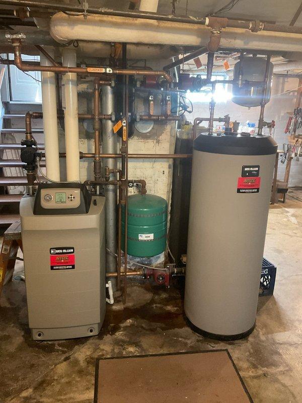 Responded to a leaking indirectly heated hot water storage tank in a century-old three-family residence. The tank is interconnected with the property's hot water boiler and heating system, serving two residential suites. Performed comprehensive annual inspection of the mechanical system, including evaluation of all copper piping connections, expansion tank, boiler interface, and associated plumbing infrastructure. Identified source of water leak at tank connections and executed necessary repairs to restore proper operation and eliminate water discharge to basement floor.