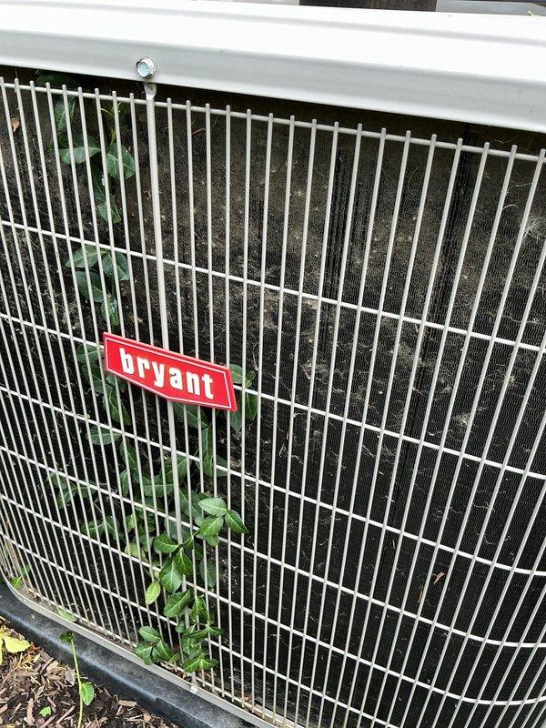 Responded to service call for Bryant condenser unit with main compressor failure to start. Upon arrival, found outdoor unit heavily clogged with accumulated dirt, dust, and debris on cooling coils and fins, with vegetation growth around base impeding proper airflow. Performed diagnostic testing on compressor and electrical components. Thoroughly cleaned condenser coils and fins to remove substantial buildup that was restricting heat exchange capacity. Cleared vegetation from around unit perimeter to restore adequate clearance for proper operation. Tested system operation following cleaning and verified compressor startup and normal function. Unit returned to full operational status with improved airflow and cooling efficiency.