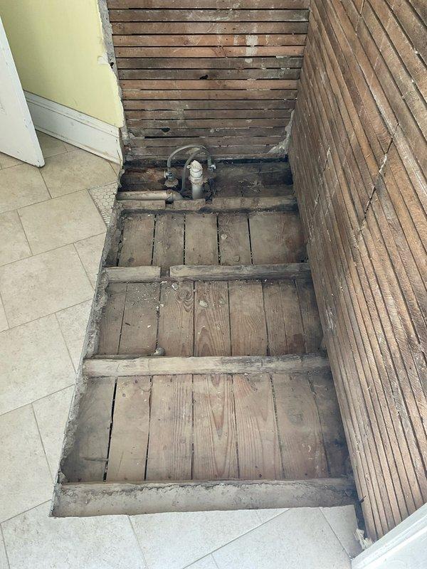 Completed rough-in installation of drain and water supply lines for shower in basement area. Performed necessary demolition work to access plumbing pathways through existing wooden stairwell structure and adjacent walls. Restored functional shower plumbing system to property that previously had no working shower facilities.