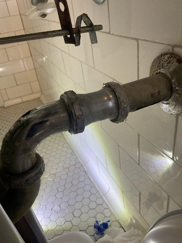 Responded to upstairs bathroom sink leak in century-old home. Upon inspection, identified active leak at supply connection and deteriorated drain piping with heavy corrosion on exposed trap assembly beneath pedestal sink. Repaired leak at supply line connection point and addressed drainage issues related to aged metal piping system. Verified proper water flow and drainage operation upon completion, with all fixtures tested and functioning correctly.