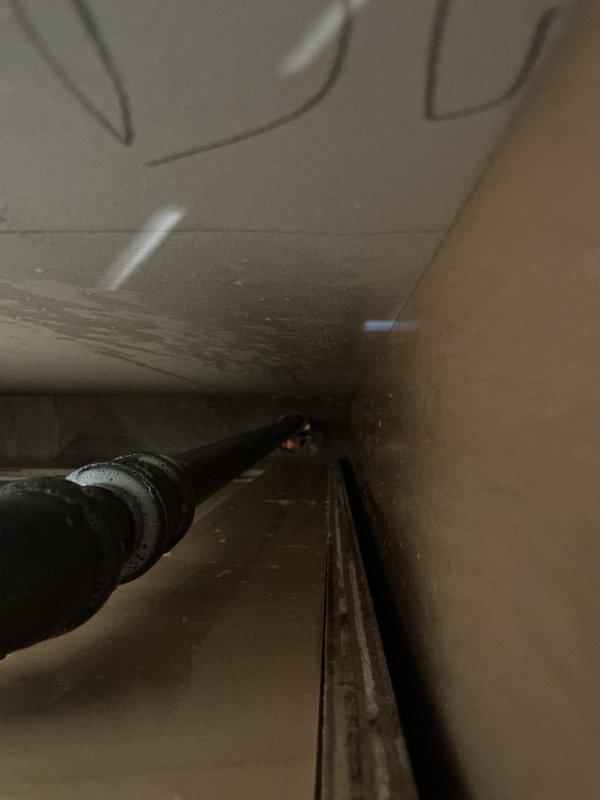 Completed plumbing installation for kitchen remodel, installing new supply lines with shut-off valve assembly under cabinet. Installed insulated refrigerant line and connected water supply piping with brass valve featuring accessible shut-off control for future maintenance access.