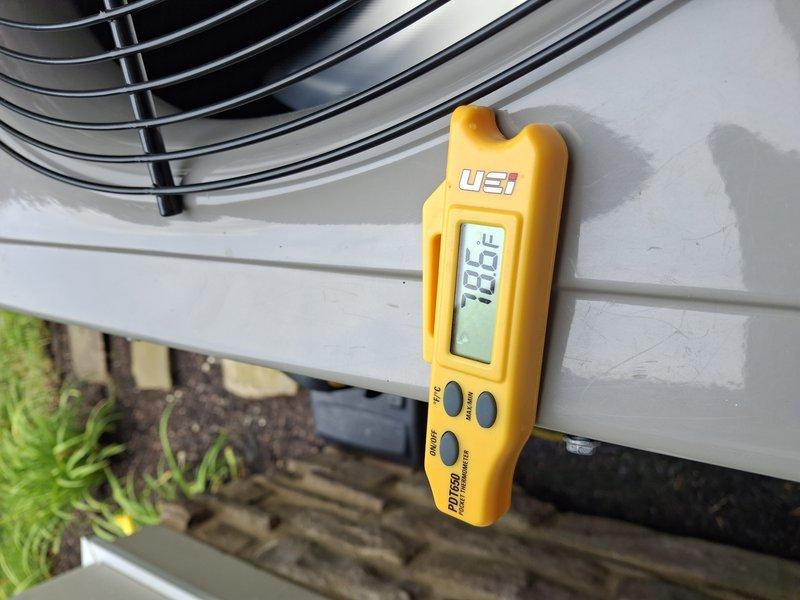 Performed routine cooling maintenance on outdoor condensing unit. Inspected condenser coil fins, noting normal dust accumulation and operational wear. Measured and recorded discharge air temperature at 106.5°F, confirming system operating within normal parameters. Unit found in satisfactory working condition with no immediate repairs required.
