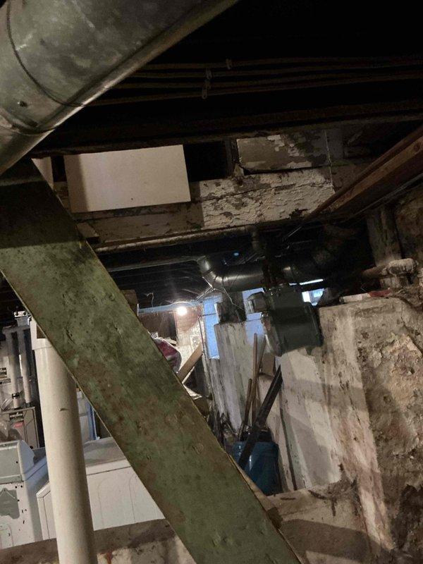 Conducted comprehensive assessment of existing HVAC system in basement mechanical room for replacement estimate. Documented aging equipment, deteriorated ductwork, and overall condition of installation area including concrete foundation showing significant moisture damage and staining. Photographed existing system configuration, structural constraints, and access points to develop accurate replacement specifications and installation plan.