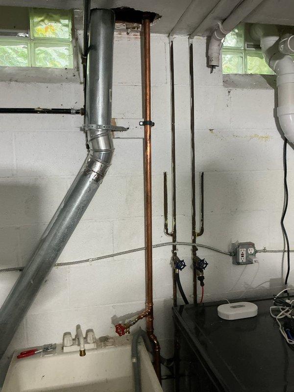 Completed plumbing inspection in basement utility area and exterior foundation perimeter. Identified multiple plumbing system components including galvanized vent stack, copper water lines, and PVC drainage piping requiring maintenance recommendations. Presented repair options to address aging galvanized piping and recommended foundation drainage improvements where vegetation growth was compromising proper water management around the structure.